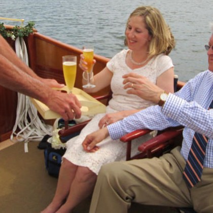 two people enjoying mimosas and private dinner on the sailboat