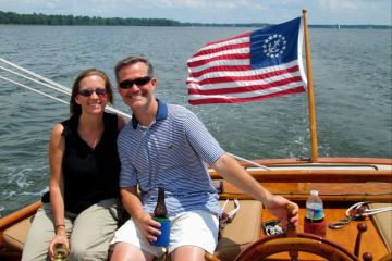 couple enjoying beverages on the front of the sailboat
