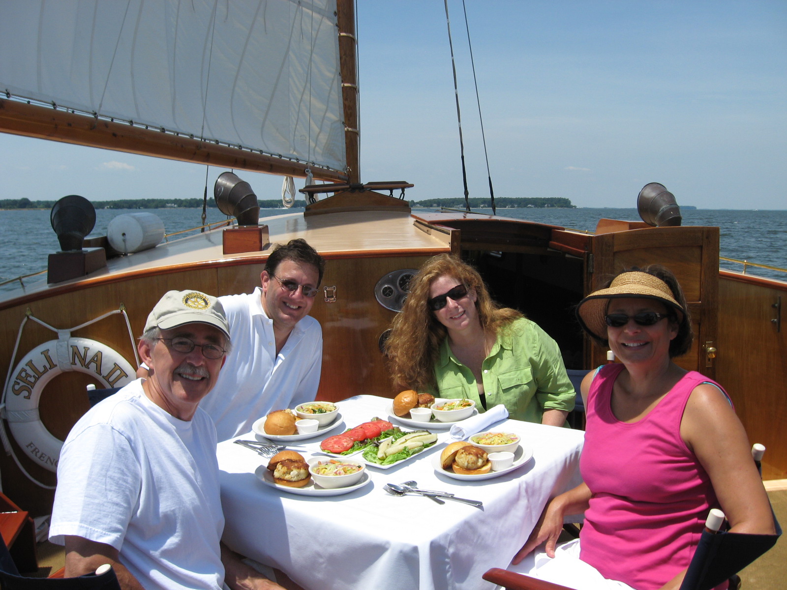 a group of people sitting at a table eating food