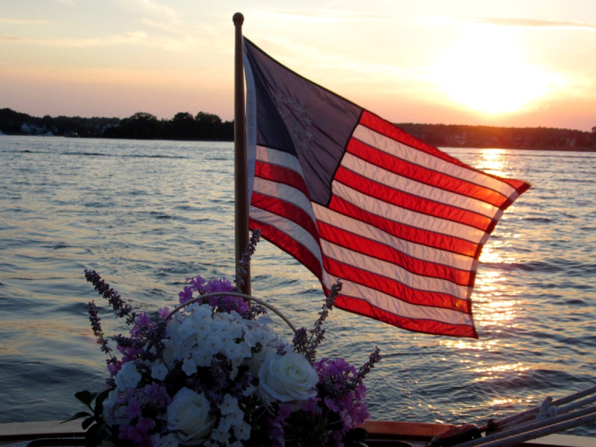 american flag and flowers on the back of the boat