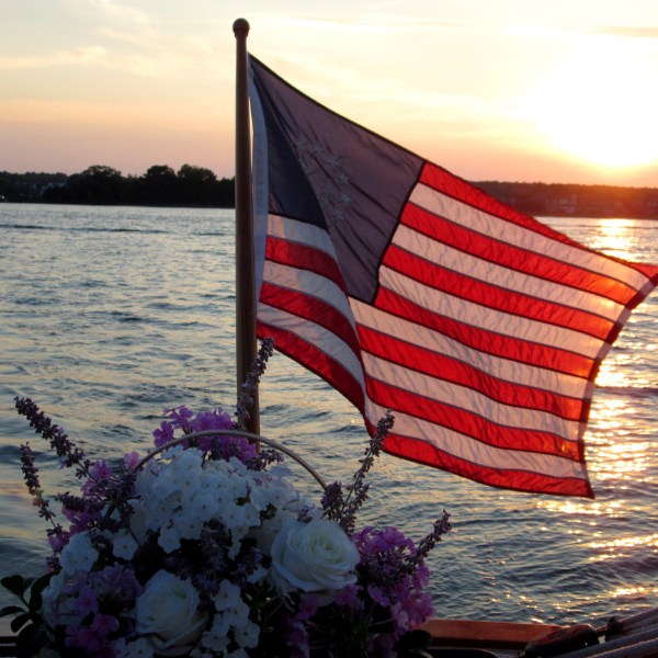 american flag and flowers on the back of the boat