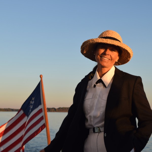 Captain Iris standing on her vessel