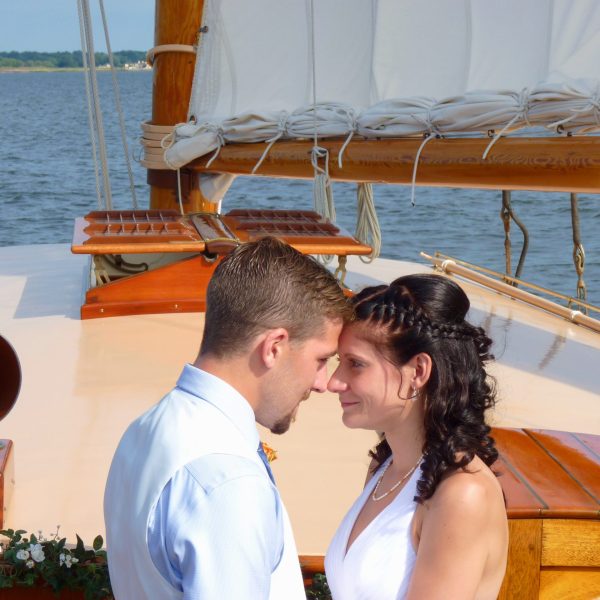 Experience the romance and adventure of a boat wedding or elopement aboard Sail Selina in St. Michaels, MD - Capturing the captivating and vibrant spirit of a newly-wed couple just like this - Book your Sail Selina adventure today!