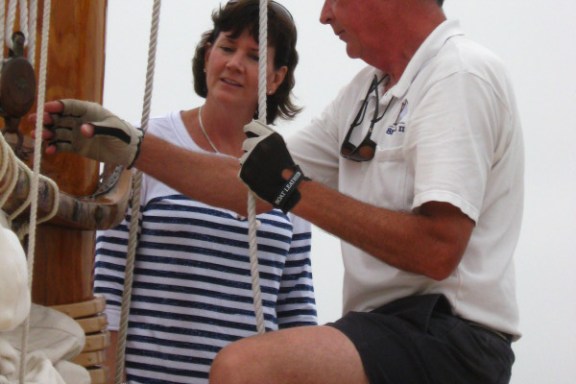man teaching sailing to a group