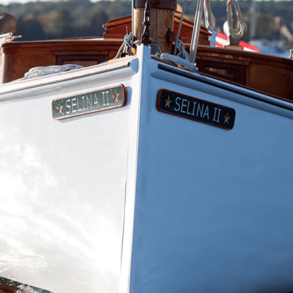 Experience the awe-inspiring elegance of Sail Selina as it glides through the water on the Chesapeake Bay in St. Michaels - This breathtaking image captures the classic and timeless beauty of a wooden sailboat as Sail Selina cuts through the waves with grace and precision - With our expert crew at the helm, witness the power and agility of Sail Selina's well-maintained boat, as you sail towards an unforgettable journey - Fall in love with the charisma and elegance of Sail Selina, a vessel imbued with history and character, sailing in the open waters - Book your sail with Sail Selina today and embark on a journey that will leave an indelible mark on your memory!