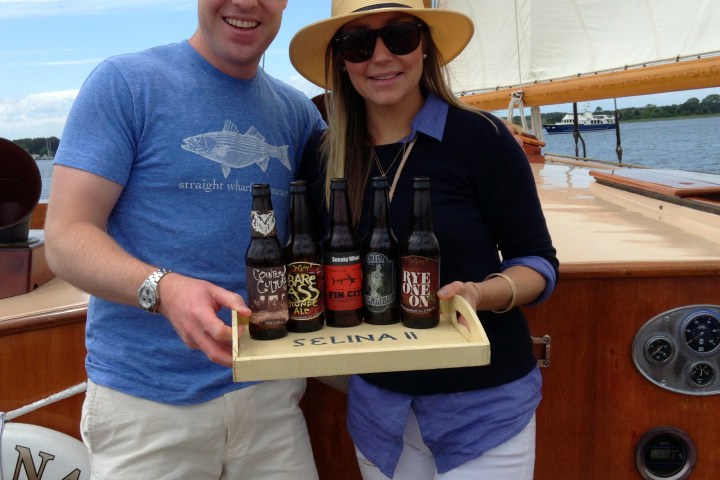 Step up your beer game with Sail Selina's private charters in style, yo! 🍺🛥️ This instagram worthy image features a couple holding a tray of Maryland's hoppiest and tastiest microbrews, and soaking up those epic bay views - Book your Sail Selina adventure now, and get ready to rep those beer-cred vibes! 🤘🏼🌊 #HipsterApproved #MarylandMicroBrews #SailSelina #StMichaelsMD