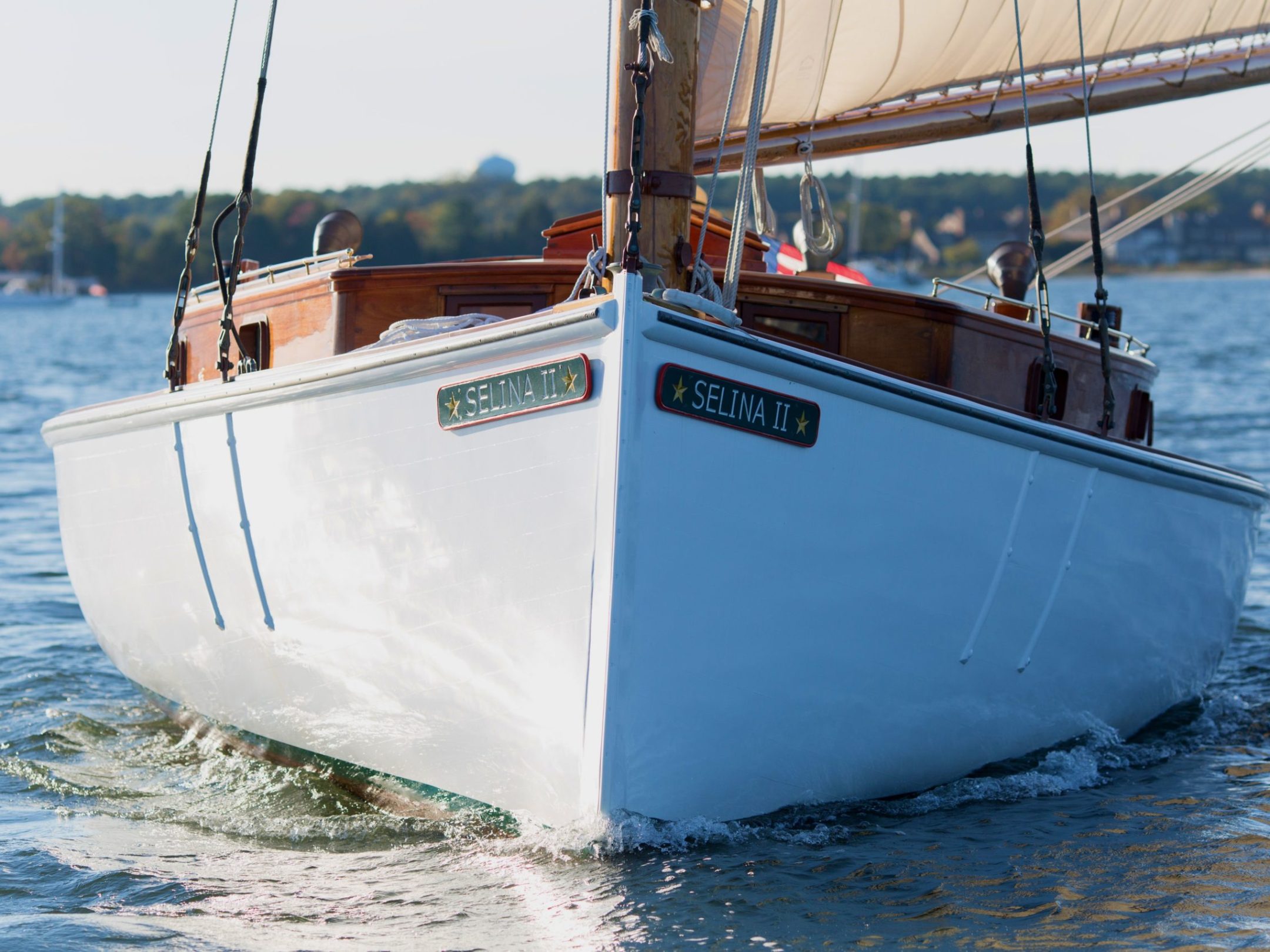 Experience the awe-inspiring elegance of Sail Selina as it glides through the water on the Chesapeake Bay in St. Michaels - This breathtaking image captures the classic and timeless beauty of a wooden sailboat as Sail Selina cuts through the waves with grace and precision - With our expert crew at the helm, witness the power and agility of Sail Selina's well-maintained boat, as you sail towards an unforgettable journey - Fall in love with the charisma and elegance of Sail Selina, a vessel imbued with history and character, sailing in the open waters - Book your sail with Sail Selina today and embark on a journey that will leave an indelible mark on your memory!