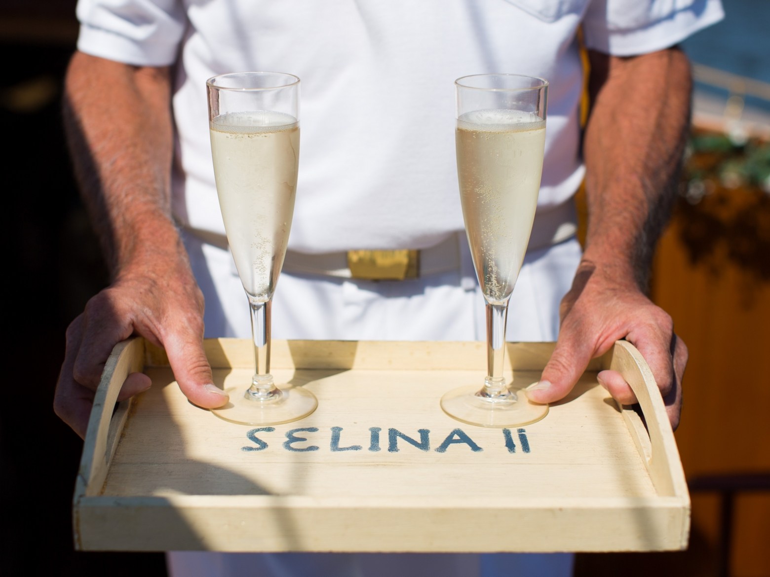 Experience a stunning sunset over the Chesapeake Bay with Sail Selina's Sunset Tour crew in St. Michaels - our first mate serves a tray of fantastic bubbly, the perfect addition to end your day - Book your experience now