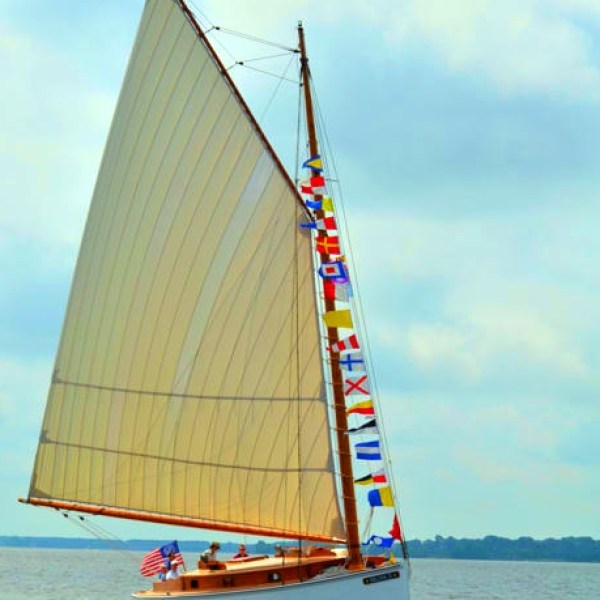 Feel the excitement and joy of a holiday weekend as Sail Selina proudly displays her signal flags in St. Michaels, MD - Experience the thrill of sailing with full sails up, book your Sail Selina adventure now