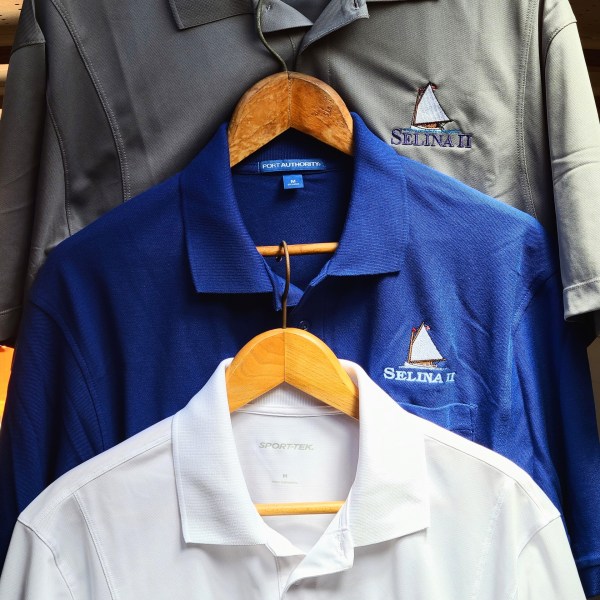 collectable Sail Selina custom logo embroidered on whit polo shirts, royal polo shirts and gray polo shirts. available in the ships store